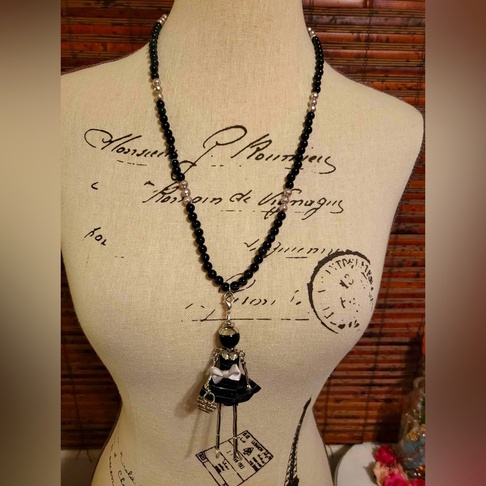 Elegant Black Beaded Necklace with Doll Pendant